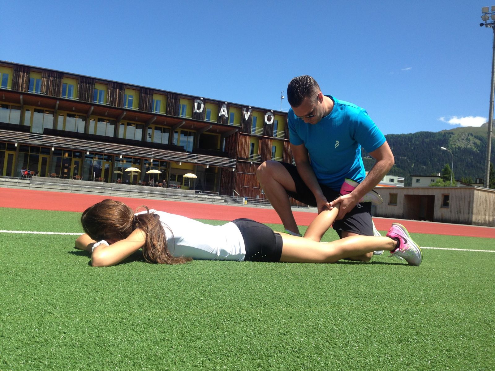Sportphysiotherapeut Philip J. Thomaschowski behandelt einen Sportler auf dem Sportplatz